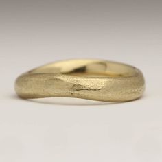 This handmade ring is sand cast in recycled 9ct yellow gold in a small sand mould. It has a really lovely natural feel and the yellow gold has a lovely sandy colour. The mould creates the texture you can see on the ring.You can buy the mould the ring is cast in if you like. If you would like to use some of your own metal or sand please get in touch with us and we can give you a quote. Each piece comes in its own sustainably sourced cork box.Our rings are always packed in a rustic cardboard box f Hand Cast Gold Engraved Wedding Ring, Gold Hand Cast Rings For Promise, 14k Gold Hand Cast Wedding Rings, Yellow Gold Hand Cast Wedding Rings, Hand Cast Gold Promise Rings, Hand Cast 14k Gold Wedding Rings, Rustic Wedding Band, Curved Wedding Ring, Rustic Wedding Bands