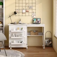 a white desk and chair in a room with yellow walls, wooden floors and windows