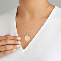 LILY & ROO's large round St Christopher medallion necklace in solid gold. This stunning large St Christopher medallion is suitable for everyday wear and perfect for layering. The large round pendant necklace features the patron saint of travellers. The perfect gift for her. All solid gold St Christophers come in a luxury LILY & ROO gift box. Give your jewellery a little TLC to keep your jewellery shining bright. Your stunning St Christopher necklace will be sent to you in a complimentary Lily & Roo gift box. 14k Gold Round Coin Necklace Fine Jewelry, 14k Gold Round Coin Necklace, Luxury Engraved Round Medallion Necklace, Luxury Round Engraved Medallion Necklace, 14k Gold Necklace With Large Round Pendant, Luxury Coin Necklace With Round Pendant, Luxury Tarnish Resistant Coin Necklace, Rose Gold Necklace With Large Pendant, 14k Gold Medallion Locket Necklace