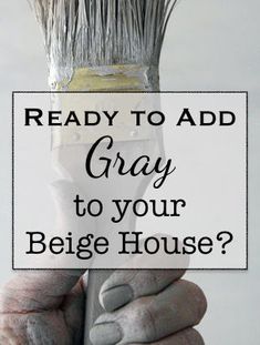 a hand holding a paintbrush with the words ready to add gray to your beige house?