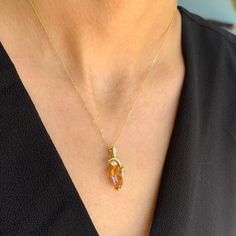 "This stunning yellow topaz and Diamond necklace has a gorgeous art deco look. It is the perfect gift for those who love art deco. It has Pave set diamonds on the leaves and comes with a 16\" chain. Please inquire if you would like a different gemstone. [MATERIALS] Stone: Topaz Carat: 6.54 Clarity: Some inclusions Color: Yellow-Orange Cut: Pear Setting: Prong Measurement of the stone: 16 mm x 10.70 mm Stones: Diamonds (92) Carat: 0.81 Clarity: SI3 Color: I-J Stone: Round Setting: Pave Metal: 3.5 Yellow Topaz Necklace, Orange Cut, Topaz Jewelry, Topaz Pendant, Yellow Gold Necklace, Topaz Necklace, Gorgeous Art, Pear Cut, Yellow Orange