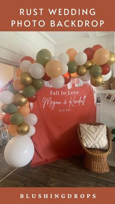 a wedding photo backdrop with balloons and a chair