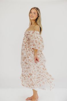 This gorgeous dress is a *vibe* and we are here for it. If you think the Harlow is stunning in photos, wait till you see it in person - this dress will make a statement wherever you go! It features incredible puffed sleeves, a bustier-style structured bodice, and a voluminous skirt. This floral gem is extra-luxe, and 100% the choice when you're looking to stand out from the crowd. Pair it with a glam set of pumps for a night at the symphony, or with heeled sandals for a baby shower - just prepar Summer Wedding Dress With Flowy Fit, Summer Wedding Dress Flowy Fit, White Flowy Dress For Garden Party, White Flowy Garden Party Dress, Chiffon Long Dress For Brunch, Flowy Chiffon Dress For Brunch, Chiffon Brunch Dress With Flowy Skirt, Flowy Long Dress For Brunch, Chiffon Dress With Flowy Skirt For Brunch