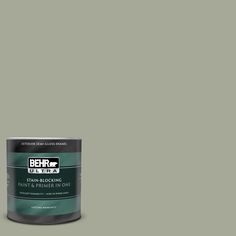 a can of behr paint on a green background