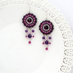 "I created this purple earring by hand, using Swarovski Rivoli (12mm) for each one, Swarovski 3mm beads, amethyst stone 6-4mm, Miyuki round seed beads, Miyuki Delica beads and Sterling Silver ear-wire Boho chic, striking and full of presence * Measurements: Earring length: 2.36\" (6cm) Pendant diameter: 0.78\" (2cm) * The earrings will come beautifully packaged for a gift. *Additional information on the matching necklace you can see here: https://www.etsy.com/listing/218652255/amethyst-crystal-n Handmade Purple Sterling Silver Chandelier Earrings, Czech Glass Dangle Earrings With Bead Caps, Purple Beaded Earrings As Gift, Purple Beaded Round Earrings For Gift, Purple Round Beaded Earrings With Ear Wire, Purple Round Beaded Earrings For Gift, Crystal Round Earrings With Ear Wire, Nickel-free Purple Sterling Silver Beaded Earrings, Silver Crystal Earrings With Dangling Beads