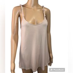 a female mannequin wearing a tan tank top