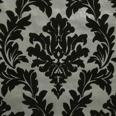 a black and white wallpaper with an ornate design on the back half of it