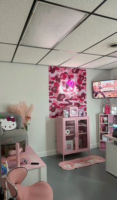 a room with pink furniture and hello kitty decorations