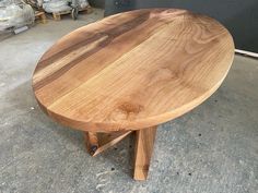 a wooden table sitting on top of a cement floor