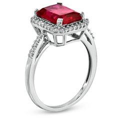 Regal and radiant, this exquisite fashion ring was designed to captivate the July-born birthday girl. Crafted in fine sterling silver, the eye is drawn to the mesmerizing 10.0 x 8.0mm emerald-cut, lab-created red ruby center stone. A frame of shimmering lab-created white sapphires surrounds the gemstone and lines the polished shank. Buffed to a brilliant shine, this ring is destined to become a treasured favorite. Custom made to fit her ring size. Sterling silver rings cannot be resized after purchase. Halo Design Radiant Cut Promise Ring, Halo Ruby Jewelry, Silver Radiant Cut Halo Jewelry, Radiant Cut Halo Setting Jewelry For Promise Ring, Radiant Cut Halo Setting Jewelry For Gift, Radiant Cut Rings With Halo Setting For Gift, Radiant Cut Jewelry With Halo Setting For Promise Ring, Radiant Cut Halo Setting Promise Ring, Radiant Cut Rings With Halo Design