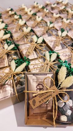 several boxes filled with cookies and candy on top of a white table covered in twine