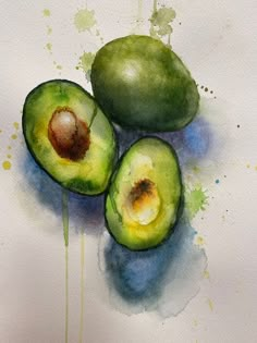 three green avocados sitting on top of a white paper covered in watercolor