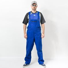 "Working overalls in blue - elastic waist - adjustable and elastic suspenders - 5 pockets - material: no label SIZE size from label: no label best fits men: L/XL MEASUREMENTS chest: free waist: 38-45 inches (96-114 cm) hips: 49 inches (124 cm) inseam: 33 inches (84 cm) The model is 6'1\" (186 cm), measures 41-35-39 (104-88-100 cm) CONDITION - 9/10 - The jumpsuit in great pre-owned condition. Washed, ready to wear." Outdoor Bib Front Overalls With Pockets, Blue Overalls With Pockets, Blue Utility Bib Front Overalls, Blue Utility Overalls With Bib Front, Blue Overalls With Pockets For Streetwear, Blue Cotton Utility Shortalls, Blue Utility Overalls For Streetwear, Mechanic Overalls, Y2k Trousers