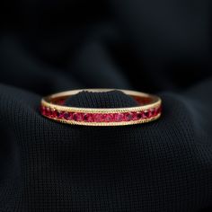 Product Details The Eternity Ring is beautifully adorned with Round Shape Ruby Gemstones in the Channel Setting. This Eternity Ring with Milgrain Detailing will be a perfect Anniversary Ring for a woman. Product Information SKU SHP-RINGS102026461 Width 1.8 mm Height 2.5 mm Weight 1.88 gm (Approximate) RUBY INFORMATION No.of Stones 34 Pieces Total Weight 2.04 Carat (Approximate) Dimension(approx) Round-2X2 mm-34 Pcs Color Red Cut Brilliant Shape Round Setting Type Channel Setting Quality Grade AAA View More Product Parent Collection Handle ruby-rings