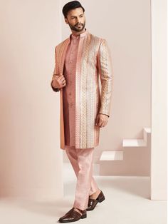 Peach colour Front Open Jacket style indo western sherwani in Silk designed with Different cut enhanced by front all over work embroidery in zari & thread on .Suitable for Indian Weddings, Bollywood parties and Indian Ceremonies, Perfect for Groom or Groomsmen,designer jacket style indowestern,designer wear for mens,designer outfit for groom COST INCLUDES INDOWESTERN JACKET,INSIDE JACKET & TROUSER Pink Long Sleeve Sherwani With Dabka Work, Pink Bandhgala With Dabka Work In Traditional Drape, Pink Bandhgala With Dabka Work For Eid, Fitted Pink Sherwani With Dabka Work, Designer Pink Sherwani With Pallu Detail, Designer Pink Sherwani With Pallu, Pink Sherwani With Dabka Work, Pink Fitted Sherwani With Dabka Work, Pink Bandhgala With Dabka Work For Reception