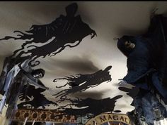 the ceiling is decorated with black and white paper cutouts that look like monsters flying over them