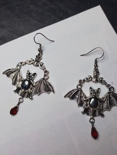 Elvira's Bat Hoop Earrings. Bat Earrings, Silver Earrings, Vintage Bat Jewelry, -Thank you for choosing us. Length - 5 cm. Width - 5 cm. CONDITION: New When placing an order, please write your phone number, this is required by the transport company. Thank you.  ❤︎ Click here to visit my store ❤︎ Dark Beauty:  https://www.etsy.com/shop/DarkBeauty8?ref=seller-platform-mcnav Bat Hoop Earrings, Gothic Hoop Earrings For Pierced Ears, Silver Gothic Hoop Earrings As Gift, Gothic Hoop Single Earring, Novelty Metal Earrings With Ear Wire, Novelty Silver Pierced Earrings, Hypoallergenic Drop Earrings For Halloween, Gothic Pierced Hoop Earrings As Gift, Gothic Hoop Earrings As A Gift