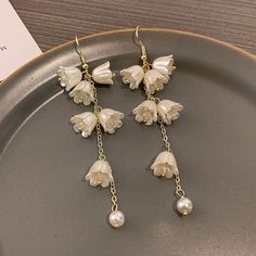 ✦ Drape yourself in the exquisite elegance of our crystal tulip flower dangle earrings, crafted to enhance the beauty of weddings and engagements. The intricate design of crystal tulip flowers exudes sophistication, adding a touch of romantic charm to your bridal ensemble. These earrings are meticulously crafted for those special moments, ensuring you shine with grace on your wedding day. The delicate dangle silhouette enhances the overall allure, creating a timeless accessory that complements y Flower Dangle Earrings, Elegant Gothic, Tulip Flower, Crystal Hoop Earrings, Nose Rings Hoop, Fashion Jewelry Earrings, Tulips Flowers, Timeless Accessories, Special Moments