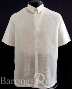 a white shirt with an intricate design on the chest