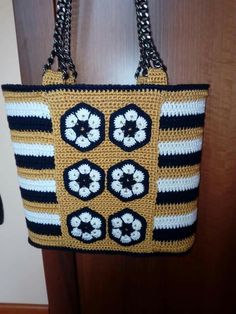 a crocheted purse hanging from a door