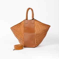 The Woven Leather All Day Tote Bag Cognac is the centerpiece of our Together Collection, and for good reason.  With at least four ways to style this tote, you can play with the silhouette by expanding or contracting the size to achieve the right look. Two large handwoven panels release into a shoulder bag, which you can open out to fit over the arm or fold up into a handheld bag.  Whatever you’re taking with you, from your laptop and lunch to makeup and heels for later, the All Day Tote is ideal Matching Keychains, Gift Bundles, Leather Conditioner, Goat Leather, 50th Gifts, Small Batch, Business Fashion, Full Grain Leather, Leather Tote