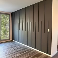 an empty room with wooden flooring and sliding doors on the wall to let in light