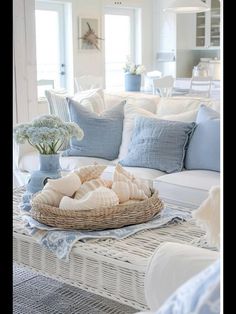 a living room filled with lots of furniture and pillows on top of a coffee table