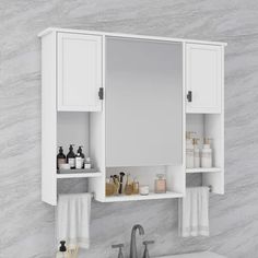 a white bathroom vanity with two medicine cabinets above it and soaps on the counter