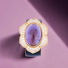 Discover the timeless elegance of our Estate Jewelry Collection with this exquisite vintage bracelet from the 1980s. Crafted from luxurious gold, this piece showcases a magnificent oval cabochon amethyst weighing approximately 87.00 carats, radiantly framed by 64 sparkling round diamonds totaling about 11.90 carats. Th Hermes Jige, Classic Glamour, Vintage Bracelet, The 1980s, Vintage Bracelets, Oval Cabochon, Jewelry Vintage, Anemone, Estate Jewelry