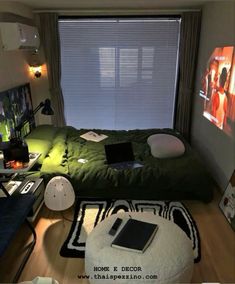 a bed room with a laptop on top of it next to a large screen tv