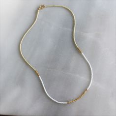 Our lithe necklace is handcrafted with a touch of gold in a minimalist style. •Seed beads in your choice of color combination •Hand strung in a modern pattern•14kt Gold-Filled beads & spring clasp •16 inches in length or 16 inches with a 2 inch extender Everyday 14k Gold-filled Necklaces With Tiny Beads, Everyday 14k Gold Filled Tiny Beads Necklace, Everyday 14k Gold-filled Necklace With Tiny Beads, Everyday 14k Gold Filled Necklace With Tiny Beads, Everyday Beaded 14k Gold-filled Necklaces, Everyday Beaded 14k Gold-filled Necklace, Everyday Beaded 14k Gold Filled Necklace, Yellow Gold Beaded Necklaces For Everyday, White Everyday Necklaces With Delicate Chain