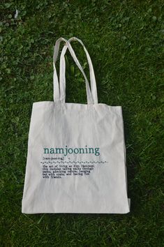 a white bag sitting on top of a lush green field