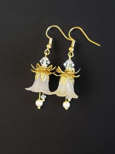 Gold Pearl Flower-shaped Earrings, Gold Pearl Flower Charm Earrings, Gold Pearl Earrings With Flower Shape, Delicate Pearl White Flower Earrings For Pierced Ears, White Flower Earrings With Pearl Drop For Jewelry Making, Delicate Flower-shaped Pearl Earrings With Ear Wire, Gold Dangle Earrings With Flower Decoration, Delicate Flower Shaped Pearl Earrings With Ear Wire, Gold Pearl Dangle Flower Earrings