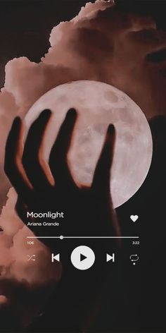 someone holding their hand up in front of the moon with clouds behind them and text reading moonlight