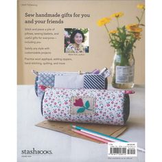 the cover of stitching magazine features an image of a pencil case and flowers in a vase