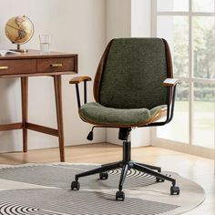 a green office chair sitting on top of a rug in front of a wooden desk