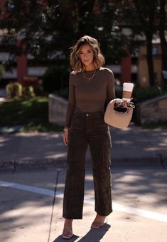 Comfy yet stylish, our Dark Olive Corduroy Cargo Pant has a high-waisted design with button and zipper closure, cargo pockets, and straight legs for an edgy look. Made of soft, stretchy corduroy, it's perfect for elevating your fall wardrobe. Ideal for a casual autumn weekend. Fabric 97% Cotton 3% Spandex Hand wash cold. Streetwear Fashion Office, Corduroy Work Outfit, Corduroy Fall Outfit, Brown And Black Fall Outfits, Mid Sized Business Casual, Fall Nice Dinner Outfit, Brown Courdory Pants Outfit 2023, Autumn Outfits Pants, Dark Earth Tone Outfits