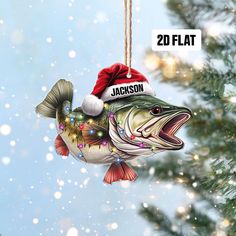 a christmas ornament hanging from a tree with a fish wearing a santa hat