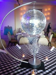 a table topped with a disco ball and candles