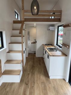 the interior of a tiny house with stairs