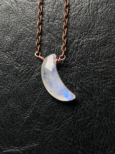 "Perfect minimalist piece for my moon goddess and child, celestial babes and witches. Petite faceted moonstone crescent moon packs quite a punch with its beautiful facets and flashy rainbows. It has been lovingly wrapped in solid copper wire onto a matching copper chain. This moon flashes, twinkles and shines so beautifully. Necklace closes with a lobster claw clasp. Necklace measures 18\" Pendant measures 1\" Moonstone is believed to develop inner growth and strength. It is believed to aide in Minimalist Moonstone Jewelry For Healing, Handmade Moonstone Moon Shaped Crystal Necklace, Handmade Minimalist Moonstone Necklace, Celestial Moonstone Wire Wrapped Necklaces, Celestial Wire Wrapped Moonstone Necklace, Celestial Moonstone Wire Wrapped Necklace, Celestial Moonstone Necklace With Wire Wrapped Details, Minimalist Wire Wrapped Moonstone Jewelry, Crescent Moonstone Jewelry For Healing