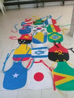 a bunch of kites laid out on the floor in front of a counter top