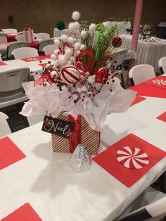 a centerpiece is decorated with candy canes and christmas decorations