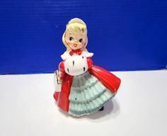 there is a small figurine that has a red and white dress on it