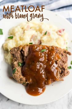 meatloaf with brown gravy on a white plate next to mashed potatoes