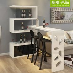 a living room filled with furniture next to a wall mounted wine bottle rack on top of a wooden floor