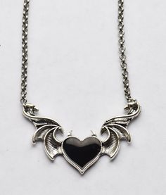 This accessory is a gothic dream come true! Become a fashion angel with this unique red heart necklace, with wings to show off your inner darkness and an 18 inch stainless steel chain to make sure you look totally devilish. Spread your love and style! Black Heart Necklace, Inner Darkness, Celtic Green, Red Heart Necklace, Fashion Angels, Crow Skull, Red Or Black, Black Crow, Enamel Pin Badge