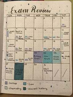 an open planner with blue and green squares on it, next to some markers that read exam review