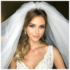 a woman wearing a wedding veil and tiara