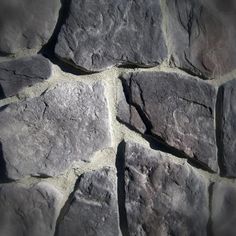 a stone wall made out of grey rocks